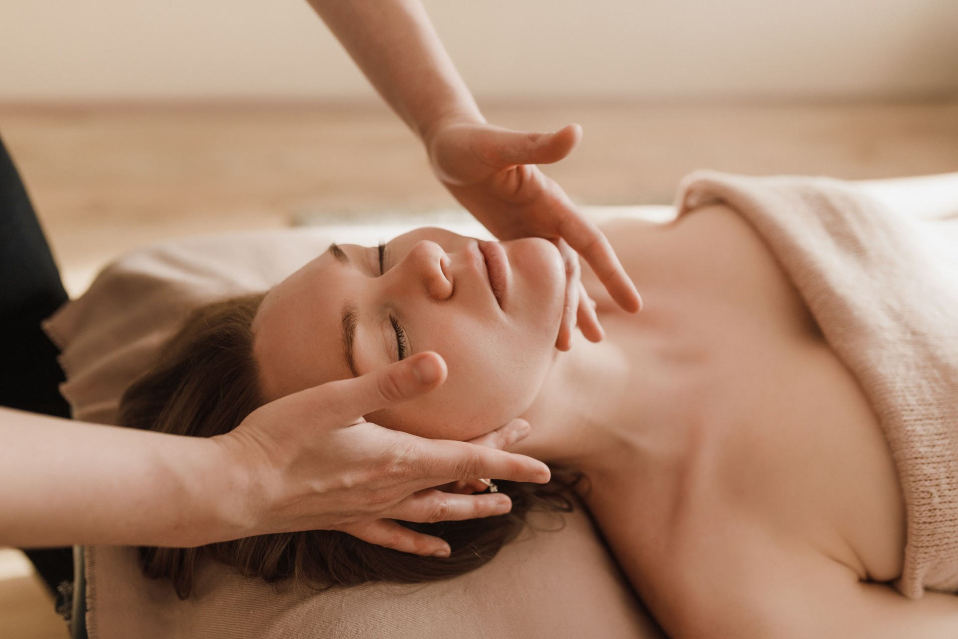 Close-up of a relaxing lymphatic facial massage at Glo Haus